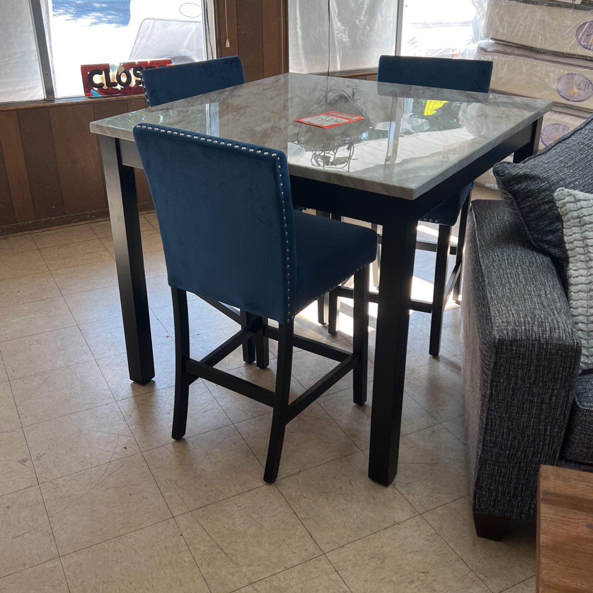 Brand new dinette with four blue stools 36 inch high table 599
