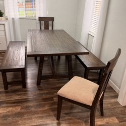 dining table with benches and two cushions chairs