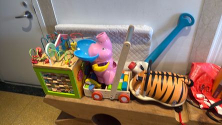 Bundle of used toys and a clean changing pad