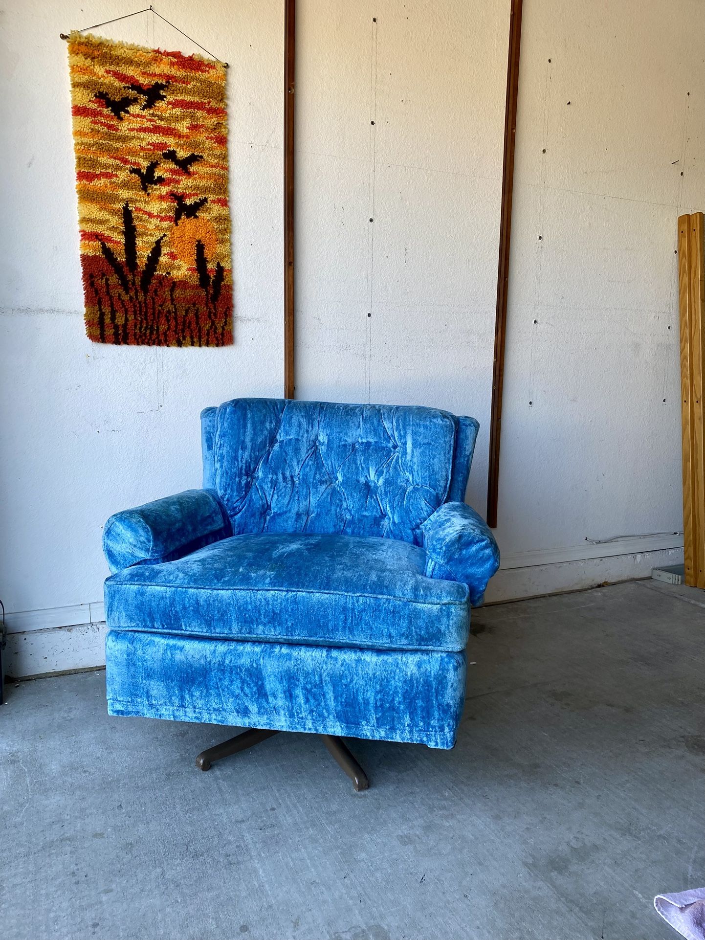 Mid Century swivel rocker chair upholstered in blue velvet