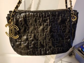 CHANEL puzzle patent leather black bag.