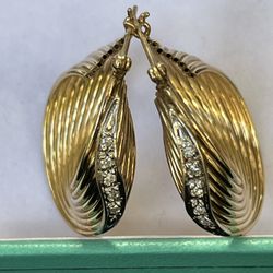 14 karat yellow gold hoop earrings with natural diamonds.