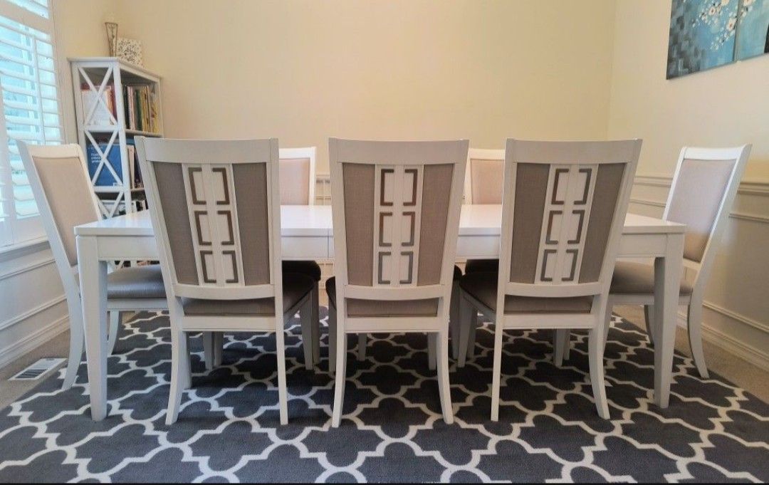 Dining set: Table, 8 upholstered chairs, rug and wall art (11 piece).