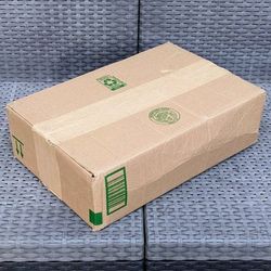 Clean medium size cardboard box with foam packing peanuts for shipping moving or storage