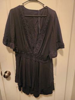 SHEIN black romper featuring flounce sleeves and delicate lace detailing around the V-neck and waist.