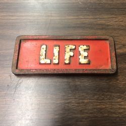 Vintage Cast Iron Life Brick Newspaper Weight