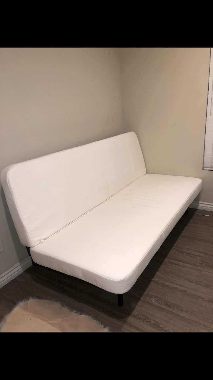 White futon on black metal frame