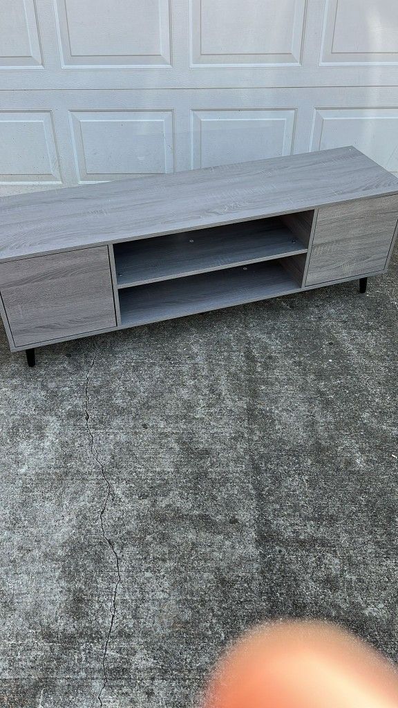 Overall size: 58 W x 16.5 D x 19 H. This TV entertainment center fits 55/65 inch TVs and the top surface supports 220 lbs.