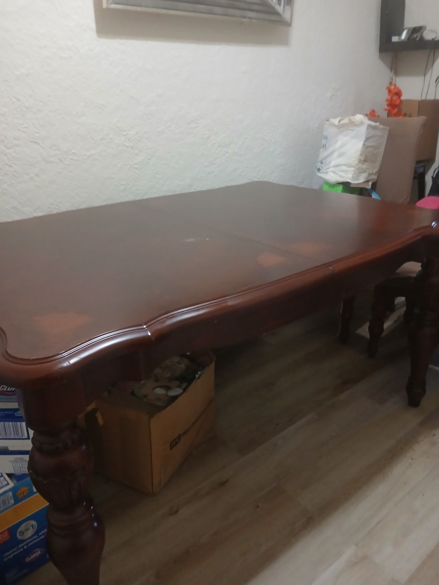 solid wood dining table with a Queen Anne style curved top and carved legs