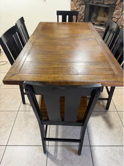 counter-height dining table with six matching chairs