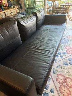 IKEA leather sleeper couch with storage for bedding