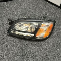 00 / 04 SUBARU LEGACY  LEFT DRIVER SIDE Headlamp w/black horizontal bar, L. OEM