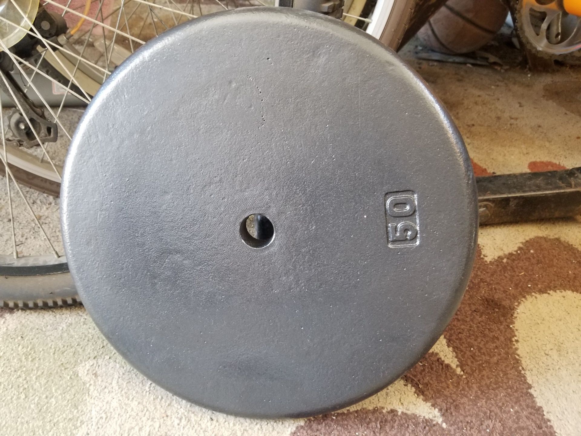 One Standard sized 50lb weight plate
