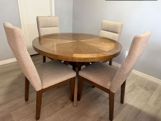 Wood dining table with 4 upholstered chairs.