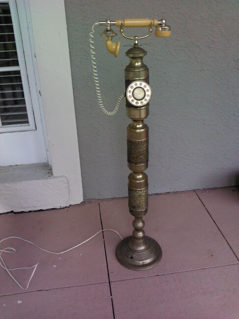 Vintage brass pedestal phone.