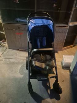 Nuna Mixx stroller features a denim blue fabric canopy and a black frame.