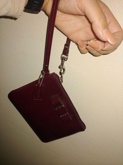 Burgundy Coach wrist wallet.