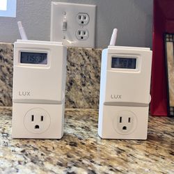 Two LUX  WIN100 Series Thermostats