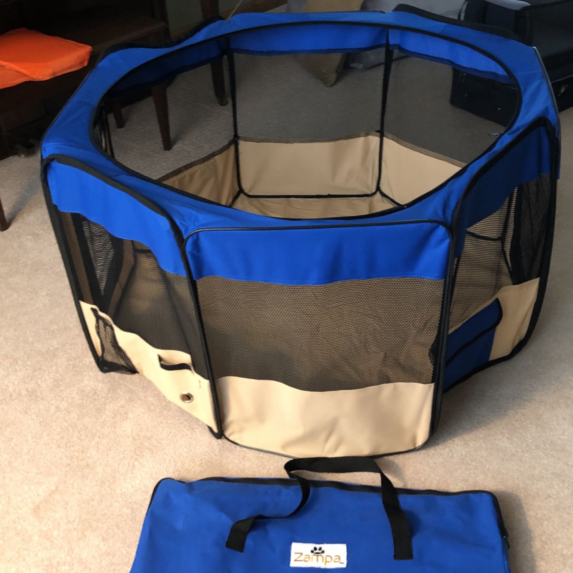 Zampa Fabric Dog Pen. 19 In Tall And 38 In Wide. Folds Down Has Mesh Zip Top And 2 Dog Doors! Comes With Carry Case To Fold And Pack Away.