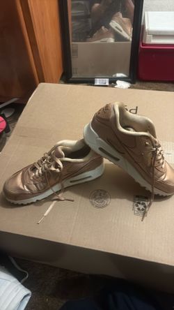 These are Nike Air Max 90 Premium Metallic Red Bronze sneakers.