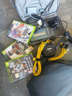 A bag full of xbox 360 accessories battery charger av cable video games some Nintendo stuff