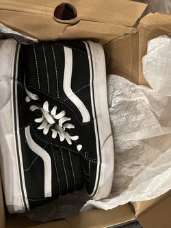 Black and white high top vans