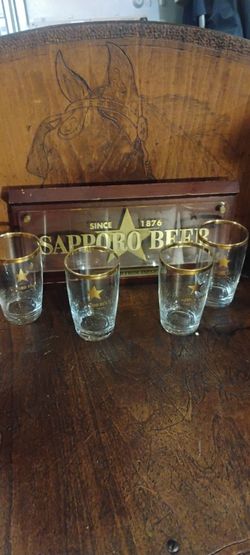 vintage Sapporo wall sign and four gold rim glases
