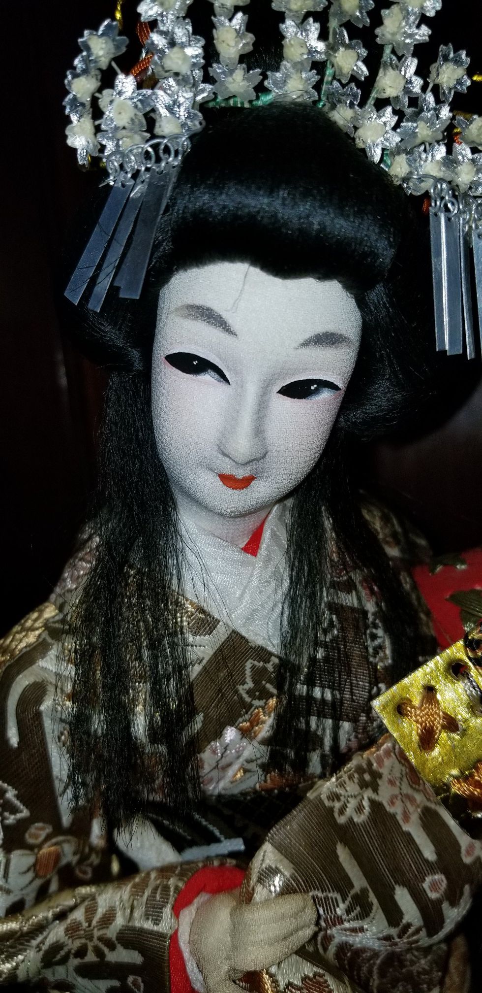 Antique Japanese Geisha doll holding warrior helmet
