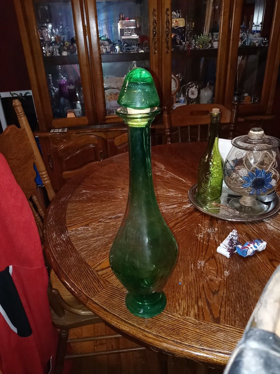 A large green glass bottle w/ top