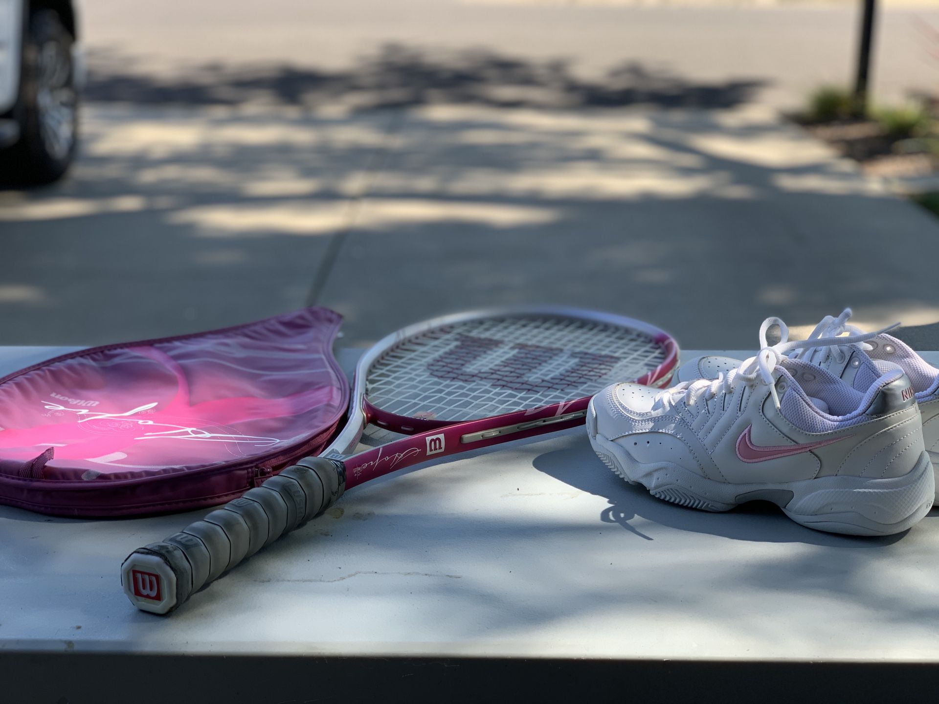 Wilson Tennis racket and Nike tennis shoes