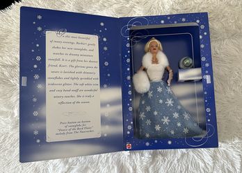 Year 1999 $30.00 Snow Sensation Barbie—a special winter edition doll dressed in a snowy-themed gown with fur trims and a snow globe accessory
