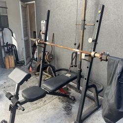 Weight Bench with Rack and Olympic Weights and Bar 