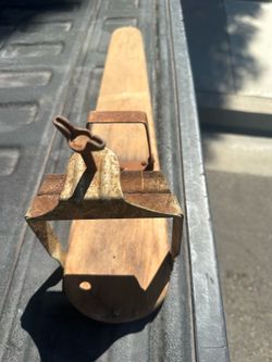 Antique clamp on ironing board for doing sleeves