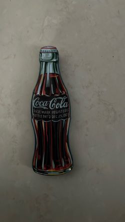 Vintage Coca-Cola case with a pin inside