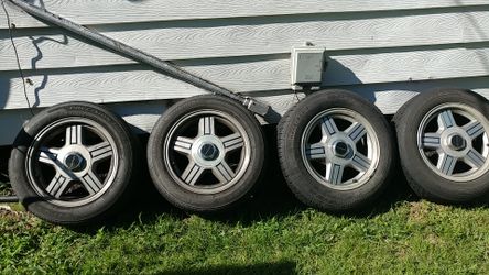 82 92 Camaro wheels and tires as you can see it s this a ful set with the caps asking only 200. for Sale in St. Louis MO OfferUp