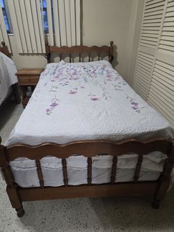 Wooden twin bed with its mattress almost new