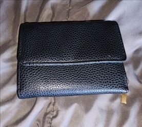 black multi-fold faux leather wallet with multiple card slots and an ID window