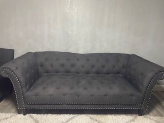 Two grey couches. They’re the same color, size, style.