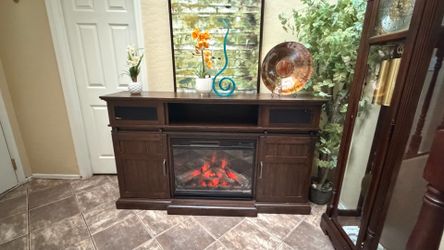 Beautiful rustic fireplace /tv stand in excellent condition 5colors of flames and speakers 68”inches long
