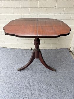 Vintage Duncan Phyfe-style mahogany flip-top game table with brass claw feet. Excellent condition.