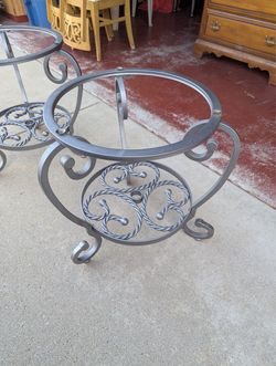A pair of matching silver metal and glass side tables