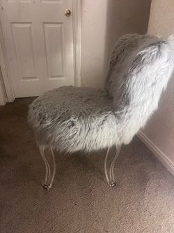 Grey furry chair with clear legs