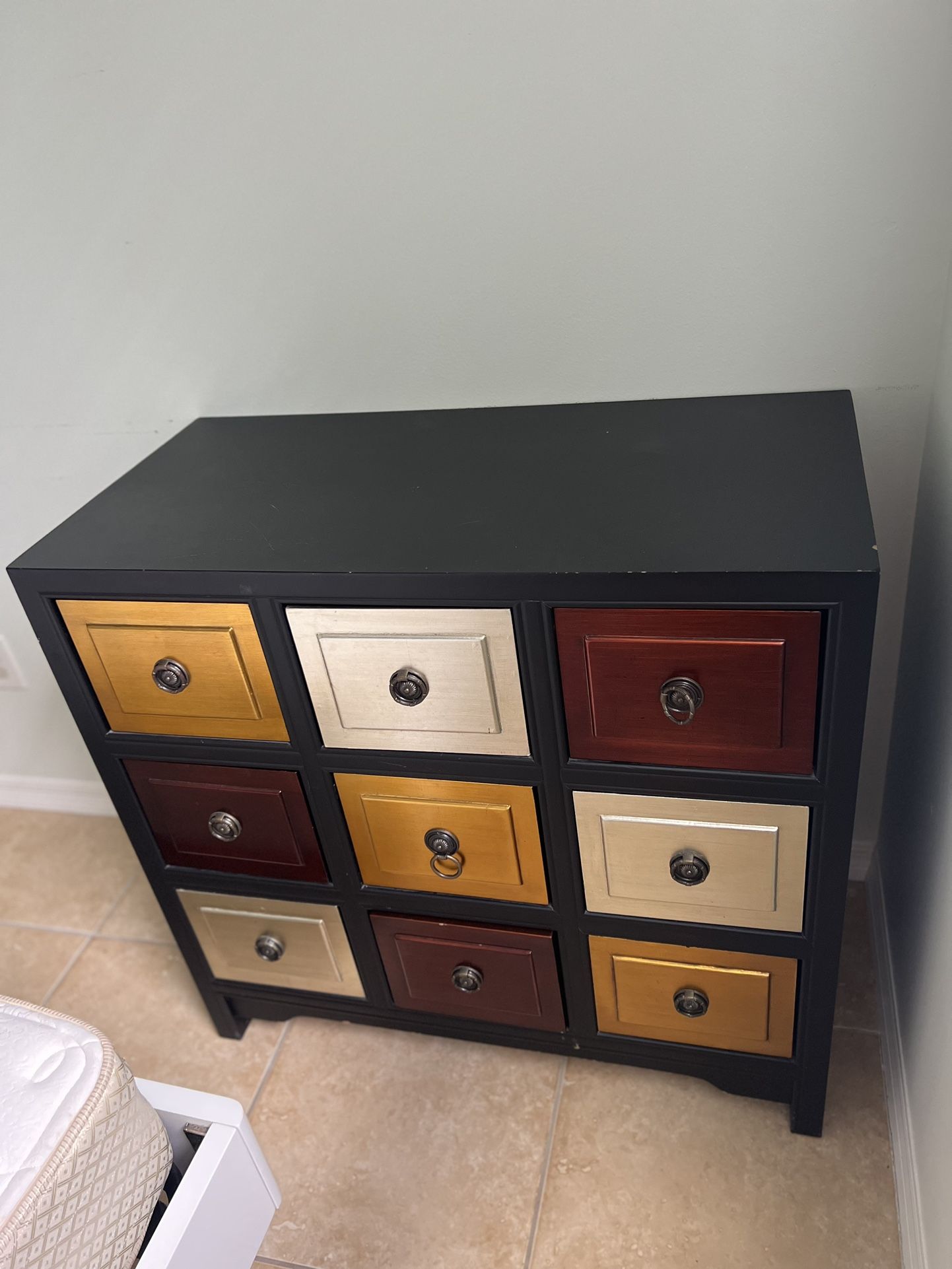 A Dresser/ Organizer With 9 Colorful Drawers