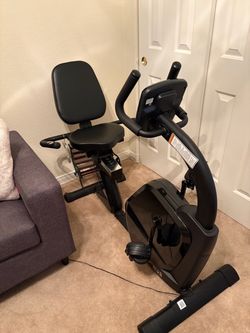 Stationery seated exercise bike