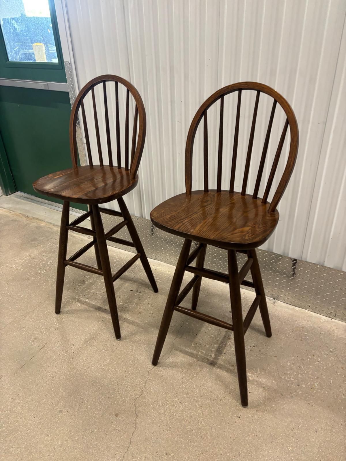 Two solid wood vintage bar stools , both swivel..