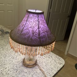 19’00 Century Beautiful lamp. Works like new. Shade Inside Is Purple and outside is Gold 