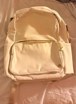Pristine Lululemon Everyday Backpack 2.0 in a cream/off-white color with gold-tone hardware.