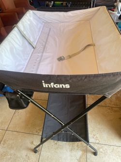 Infans folding diaper changing table with waterproof pad, integrated ruler and side storage pockets