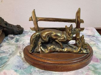 Vintage solid brass deer figurine on wooden base.