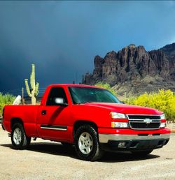 For sale: Original 2006 Chevy Silverado wheels, including tires that are practically new—4 wheels and 4 tires, complete with center caps.